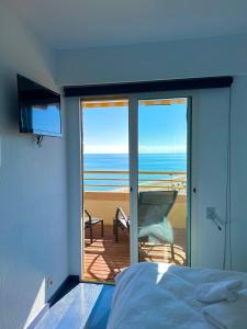 a bedroom with a bed and a view of the ocean at SUNSET Beach in El Campello +34 photos