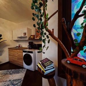 a kitchen with a microwave and a table with books at Triplex house with Bridge view in Istanbul