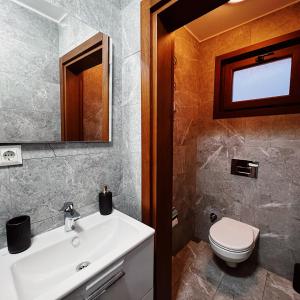 a bathroom with a sink and a toilet and a mirror at Triplex house with Bridge view in Istanbul