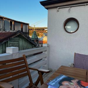 a balcony with a chair and a table and a window at Triplex house with Bridge view in Istanbul