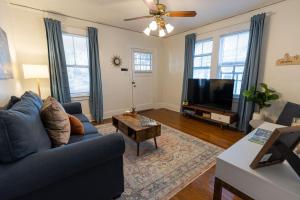 a living room with a blue couch and a tv at Historic Revival King Bed Midtown Memphis 68 Yes Pets Fast Wifi Free Parking in Memphis