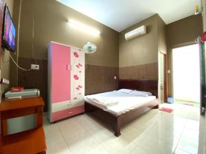 Schlafzimmer mit einem Bett und einem rosa Schrank in der Unterkunft Thu Đô Motel in Vũng Tàu
