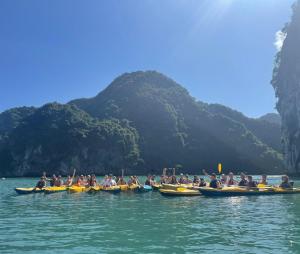 a group of people in kayaks in the water at Luna's House Hostel in Cat Ba