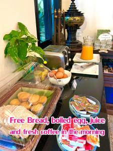 uma mesa com uma bandeja de pão e café fresco pela manhã em Wualai Sabaidee em Chiang Mai