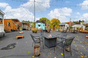 a patio with chairs and a table with a fire at Tiny Digs - Hotel of Tiny Houses in Portland