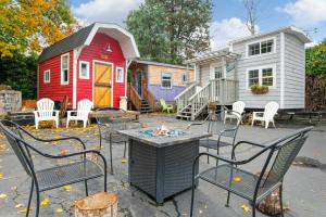 a patio with chairs and a table and a house at Tiny Digs - Hotel of Tiny Houses in Portland