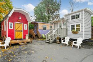 a red and white tiny house and a white house at Tiny Digs - Hotel of Tiny Houses in Portland
