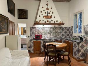 a kitchen with a table and a kitchen with a refrigerator at Once Upon a Time in Bologna