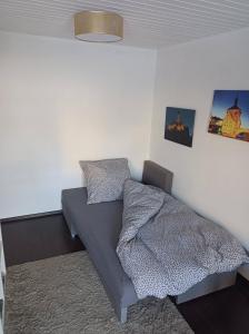 a bedroom with a bed and two pictures on the wall at Relaxen vor den Toren Bambergs in Bischberg