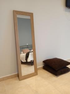 a mirror in the corner of a room with a bed at Aelia Boutique Apartments in Argostoli