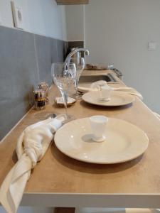 a kitchen counter with plates and glasses on it at Aelia Boutique Apartments in Argostoli