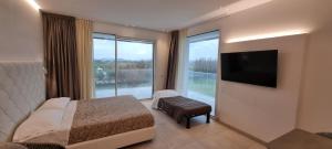 a hotel room with a bed and a large window at Hotel Residence Imperial in Misano Adriatico