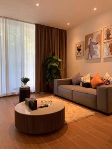 a living room with a couch and a coffee table at Guangzhou Fangyuan Hotel - Free Shuttle Bus to Canton Fair Complex during 14th Oct to 3rd Nov in Guangzhou