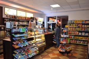 a person standing in a grocery store aisle at Hotel i Restauracja Jaskolka in Alojzów