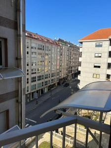 a view of a city street from a balcony at Piso Confort y Detalles Ourense in Ourense