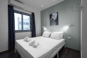 A bed or beds in a room at Aelia Apartments, The Luxury Suites
