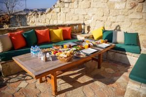 a table with food on top of a couch at 4 Oda Cave House - Special Class in Ürgüp