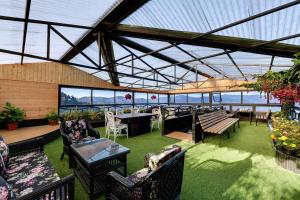 a patio with tables and chairs and a view of the ocean at Sumitel Vista 800m from Mall Road in Darjeeling +46 photos