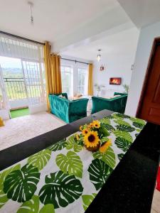 a living room with a bed with flowers on it at Cossy homes kericho grey point in Kericho