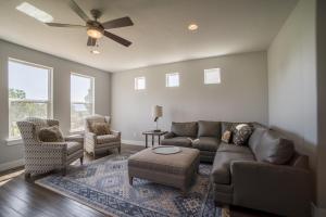 a living room with a couch and chairs and a ceiling fan at Family Vacation-Crater Hot Spring, Tubing & Ice Skating-Kanton apts in Midway