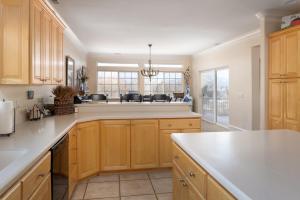 a kitchen with wooden cabinets and a white counter top at Family Getaway-Hot Tub, Ice Castles & Tubing HS home in Midway