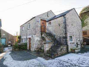 an old stone house with a staircase on it at Granary in Ulverston