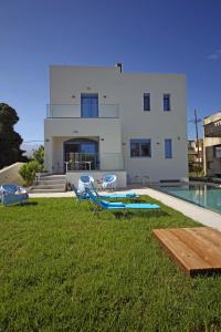 a villa with a swimming pool and a house at Ciel Villa in Kalyves