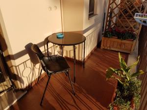 a small table and a chair on a balcony at B&B Monté in Montesilvano