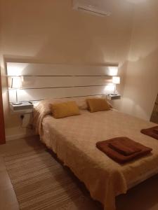 a bedroom with a bed with two towels on it at Klimataria B2 in Pissouri +19 photos