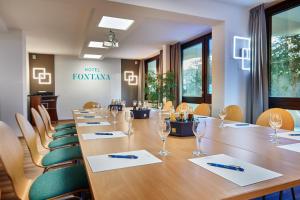 a conference room with a long table and chairs at Hotel Fontana in Bad Kissingen
