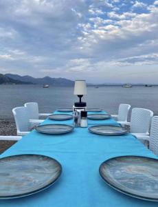 a table with plates on it with a view of the water at Hotel Turunç-Malmen in Turunç