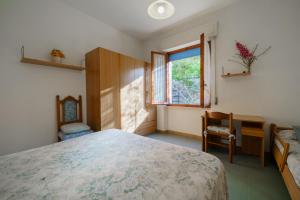 um quarto com uma cama grande e uma janela em Appartamento Pomonte la Posta - Goelba em Pomonte