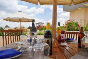 einen Holztisch mit Weinflaschen auf einer Terrasse in der Unterkunft Peaks Hotel Nanyuki in Nanyuki