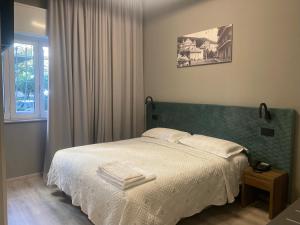Кровать или кровати в номере Hotel Graziella
