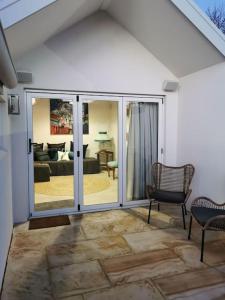 a living room with sliding glass doors and a living room at The Shoemaker's Cottage in Richmond