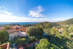 a view of a town with trees and the ocean at Cala Azzurra a Fetovaia - Goelba in Fetovaia