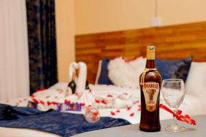 a bottle of beer sitting on a table with a wine glass at SOUTHLAKE FULLY FURNISHED TWO BEDROOMS APARTMENTS in Naivasha