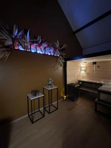a room with two tables in a room with a couch at Intimate - Private Wellness in Héron