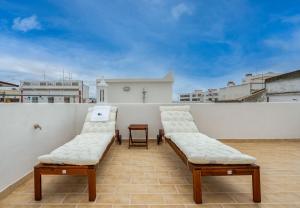 two white chairs sitting on top of a roof at Tia Anica House II - apartment with terrace in central Fuseta beach village in Fuzeta
