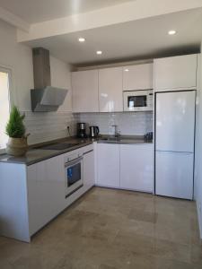 a white kitchen with white cabinets and appliances at Costa del sol, Marina del Mar in Mijas Costa