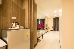 a kitchen with a refrigerator and a long hallway at Crystal Palace Luxury Hotel Pattaya in North Pattaya