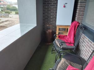 two chairs sitting on the side of a building at Hotel Golden Dragon in Dessel