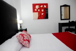 Postel nebo postele na pokoji v ubytování Hostal El Capi