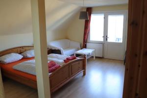 a bedroom with a bed and a large window at Pension Lotte in Kühlungsborn +12 photos