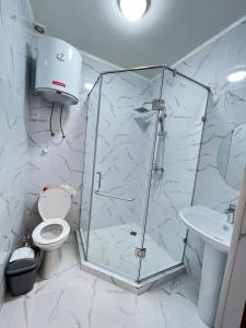 a bathroom with a shower and a toilet and a sink at Motel Oson in Chichkan Gorge, Toktogul, Kyrgyzstan, Мотель Осон в ущелье Чычкан, Токтогул, Кыргызстан in Dzhenish