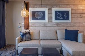 a living room with a couch and pictures on the wall at Hyatt Regency Mission Bay Spa and Marina in San Diego