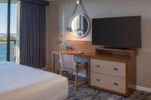 a hotel room with a desk with a tv and a bed at Hyatt Regency Mission Bay Spa and Marina in San Diego