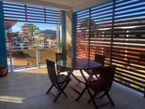 a table and chairs on a balcony with a view of a city at Résidence Beyt Salama - T1bis ou T4 in Diego Suarez