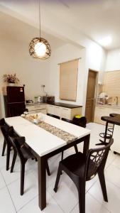 a dining room table and chairs in a kitchen at The Quintet Condominium 3-1 in Tanah Rata