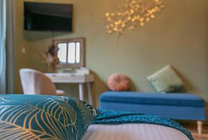 een slaapkamer met een bed, een stoel en een bureau bij The Newport Lodge - incl Breakfast, 3u Wellness and Ebike in Nieuwpoort